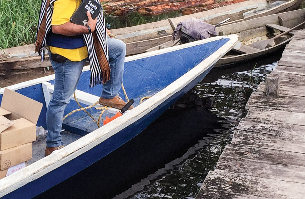 Former Zapatista Member Becomes Street Evangelist Man standing on a small boat holding a bible