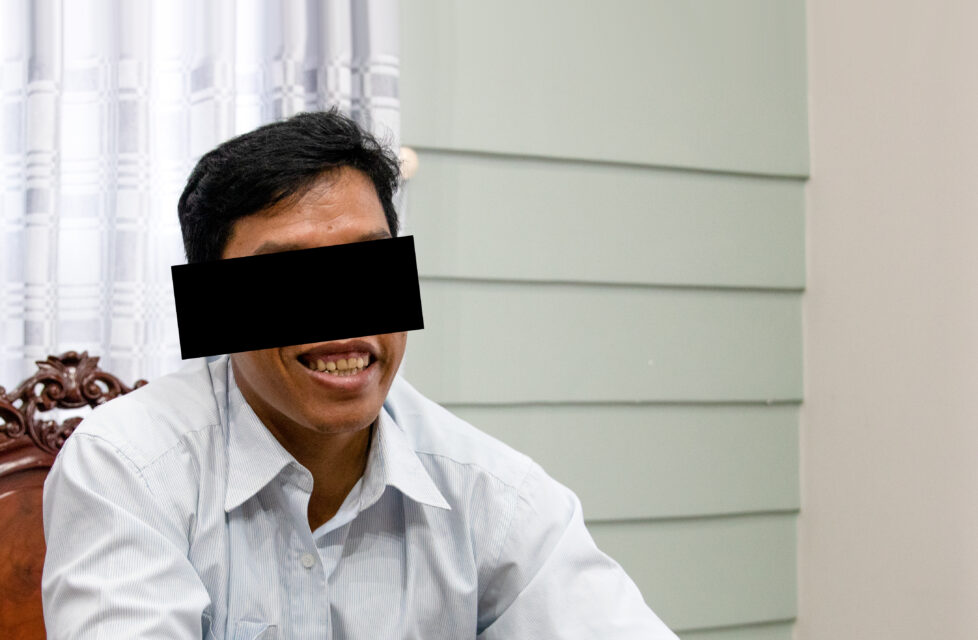 Vietnam Front-Line Worker Follows in His Father’s Footsteps Vietnam front-line worker smiles and sits in chair