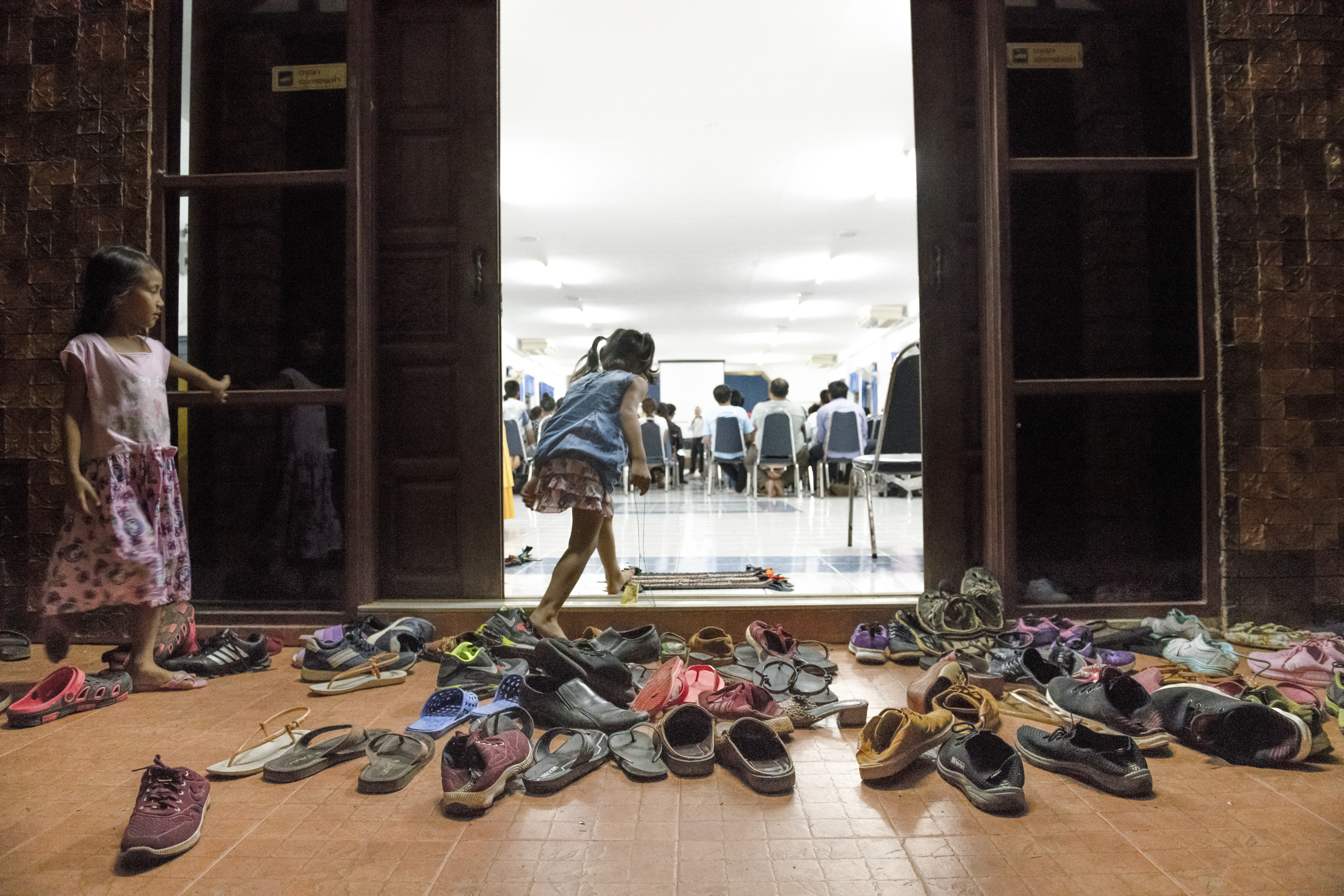 a group of children's shoes outside a door