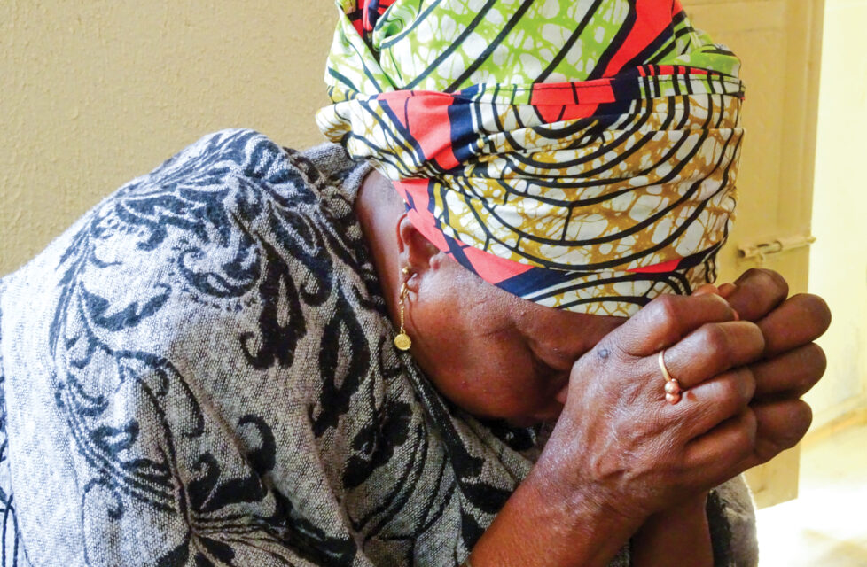 Nigerian Christians Grieve Family Killed in Boko Haram Attacks A woman praying