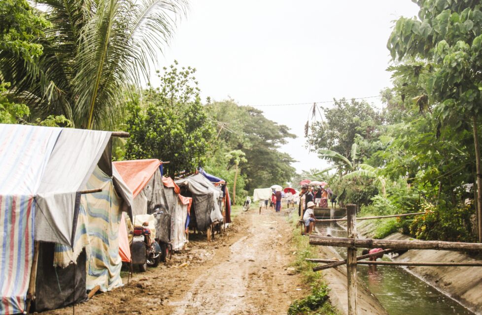 Mindanao Village Repeatedly Attacked, Christians Do Not Leave a dirt road with tents on the side