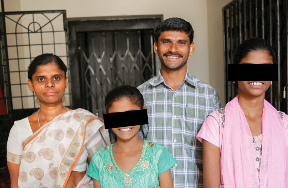 Indian Pastor Kidnapped by Hindu Yuva Vahini Youth Militia A family looking at the camera and smiling