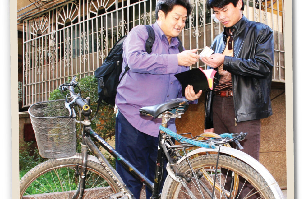 Chinese Pastor “Bike” Shares the Gospel from His Bicycle Man sharing the gospel to another man